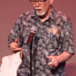 A man telling a story at a microphone