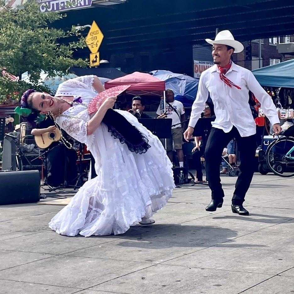 Two dancers at Corona Plaza