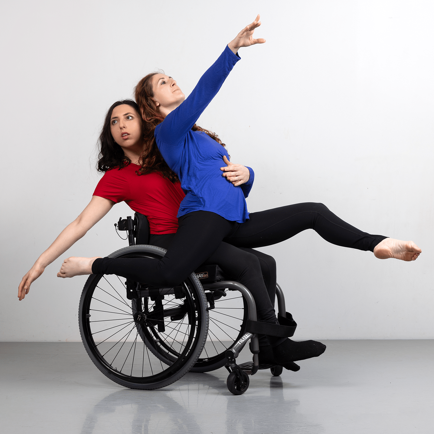 Photograph of two dancers from Full Radius Dance, one in a wheelchair