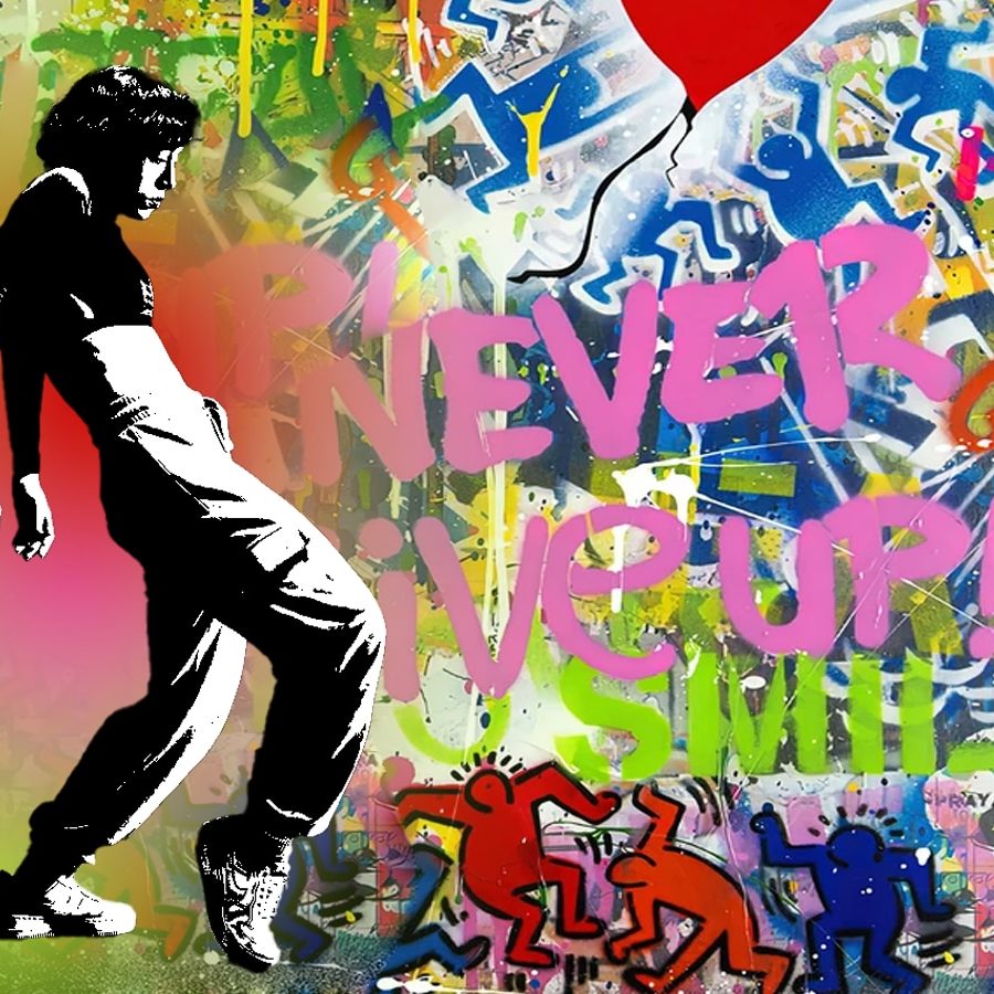 A black and white image of a person in a dance move in front of a graffiti art background